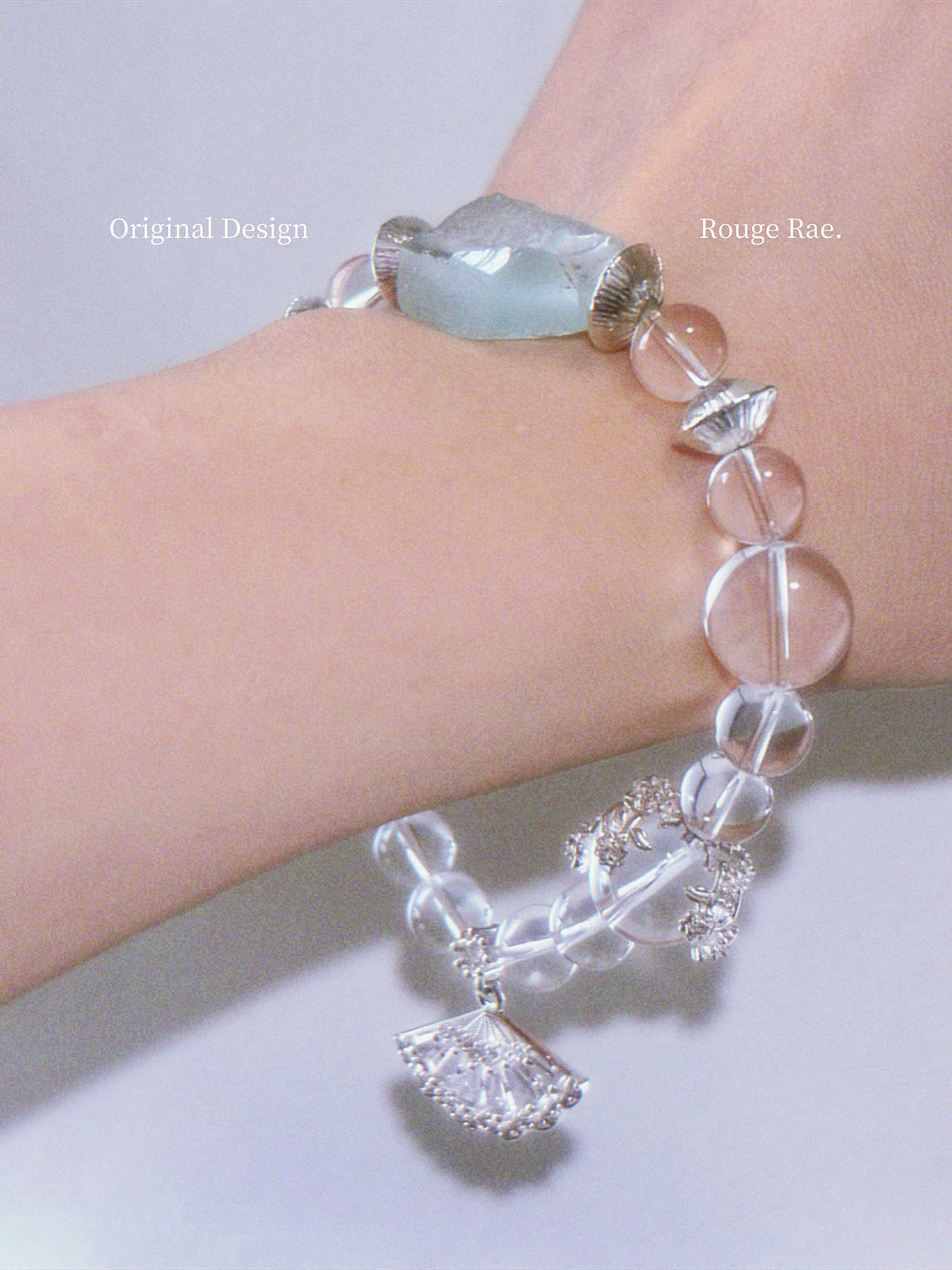Bracelet with clear and mint beads on a wrist