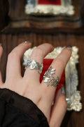 Wild rose ring worn with laurel leaf ring on hand