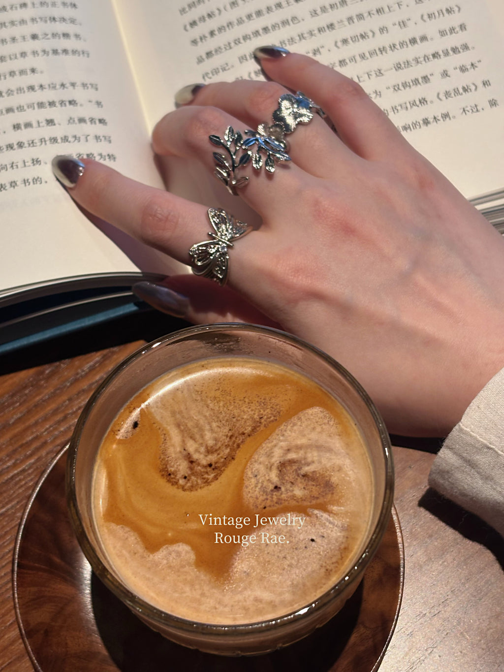 Wild rose ring stacked with butterfly and laurel rings on hand
