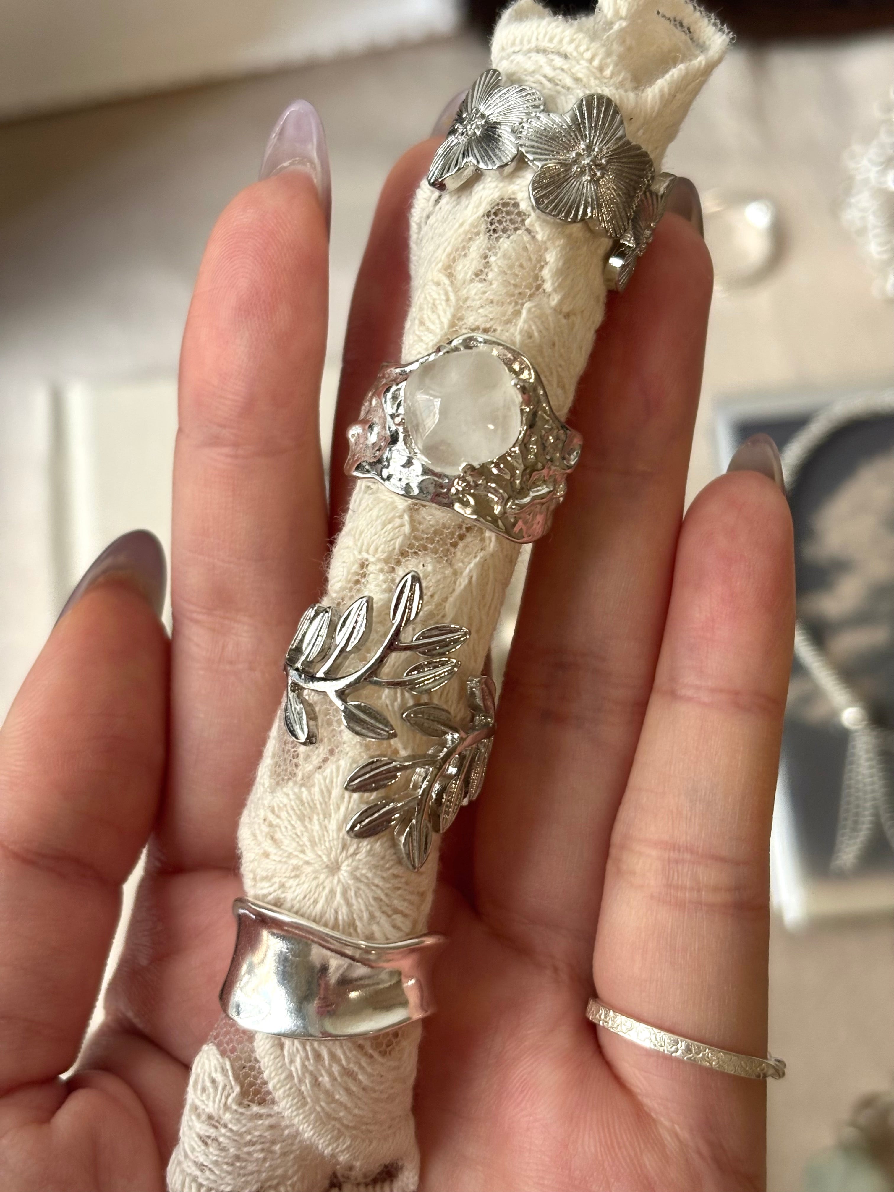 Wild rose ring stacked with cuff, clear crystal, and laurel leaf rings